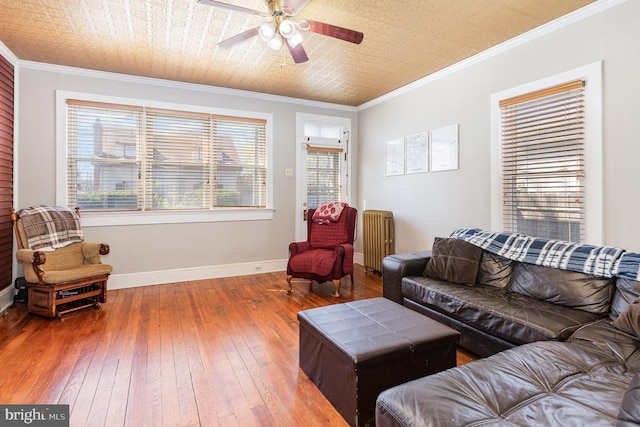 1751 Temple Ave, Lancaster, PA 17603 - living room featuring radiator heating unit, wood-type flooring, baseboards, a ceiling fan, and ornamental molding