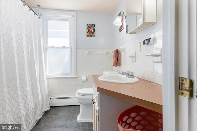 1751 Temple Ave, Lancaster, PA 17603 - bathroom featuring a baseboard heating unit, tile walls, tile patterned floors, toilet, and vanity