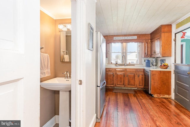 1751 Temple Ave, Lancaster, PA 17603 - kitchen with stainless steel appliances, a sink, brown cabinetry, dark wood-type flooring, and light countertops