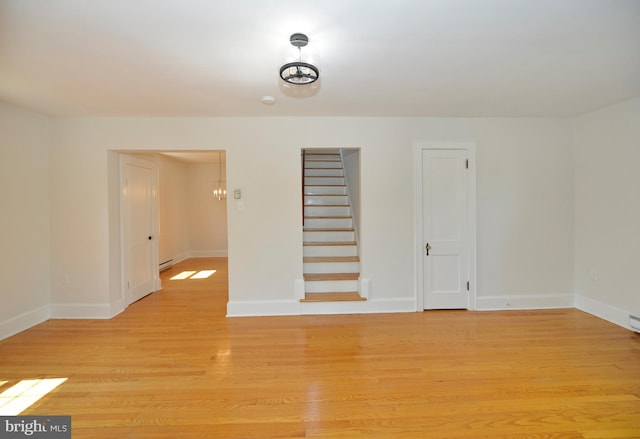 31 W Whitlock Ave, Winchester, VA 22601 - empty room featuring light wood-style flooring, baseboards, stairway, and baseboard heating