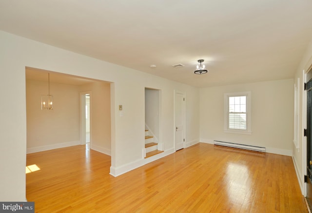 31 W Whitlock Ave, Winchester, VA 22601 - spare room with a baseboard radiator, a chandelier, light wood-style floors, stairs, and baseboards