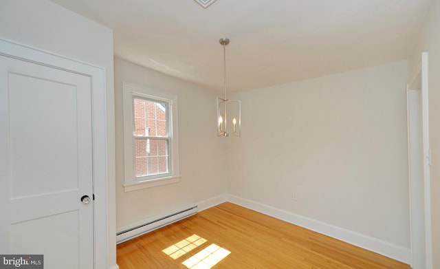31 W Whitlock Ave, Winchester, VA 22601 - unfurnished dining area with a baseboard radiator, light wood-style floors, baseboards, and a chandelier