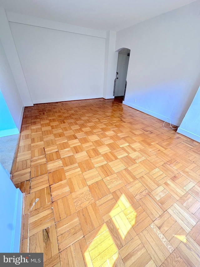 2515 K St NW Unit 205, Washington, DC 20037 - empty room with arched walkways and baseboards