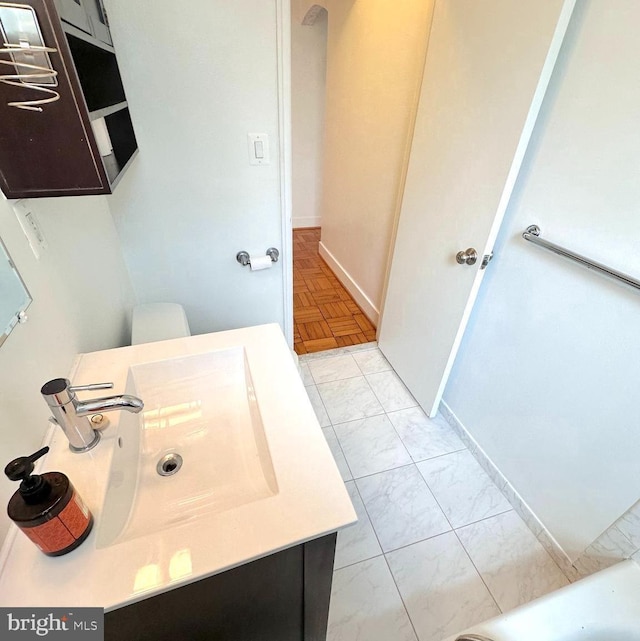 2515 K St NW Unit 205, Washington, DC 20037 - bathroom featuring marble look tile flooring, vanity, and baseboards