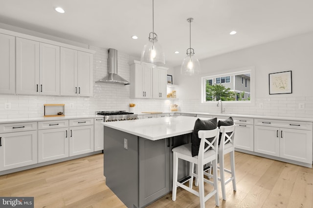 5421 4th St S, Arlington, VA 22204 - kitchen featuring wall chimney exhaust hood, white cabinetry, decorative backsplash, recessed lighting, and a sink
