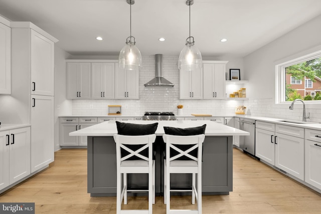 5421 4th St S, Arlington, VA 22204 - kitchen with wall chimney range hood, stainless steel dishwasher, a sink, stove, and a kitchen bar