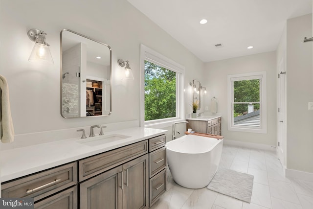 5421 4th St S, Arlington, VA 22204 - bathroom with vanity, healthy amount of natural light, a freestanding tub, baseboards, and recessed lighting