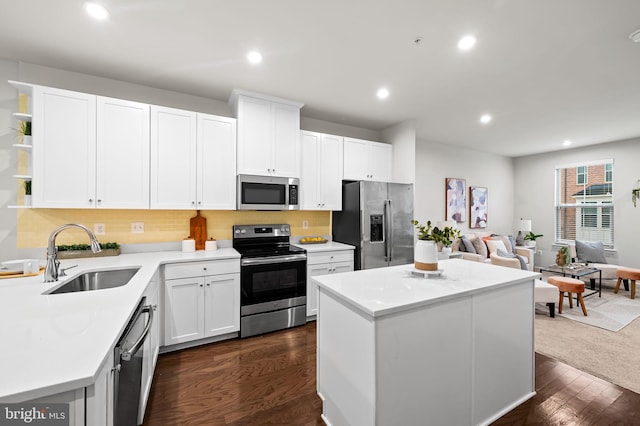 229 S Macon St, Baltimore, MD 21224 - kitchen with stainless steel appliances, a sink, open shelves, a kitchen island, and white cabinets
