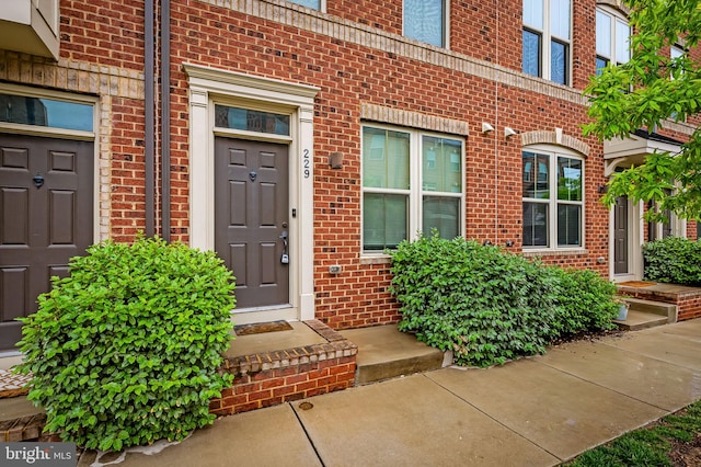 229 S Macon St, Baltimore, MD 21224 - doorway to property featuring brick siding