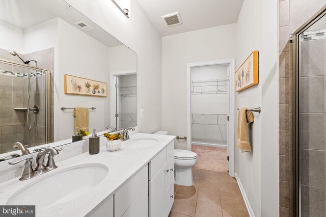 229 S Macon St, Baltimore, MD 21224 - full bath with a spacious closet, toilet, double vanity, and a shower stall