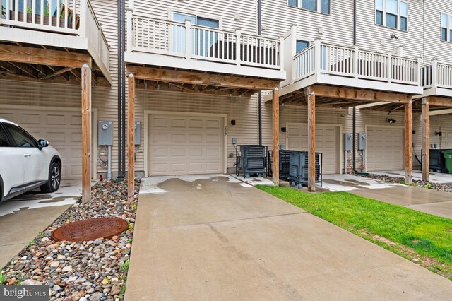 229 S Macon St, Baltimore, MD 21224 - view of side of property with an attached garage, driveway, and a deck