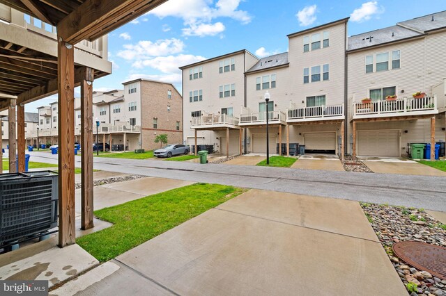 229 S Macon St, Baltimore, MD 21224 - view of yard featuring a residential view, central AC unit, and a garage