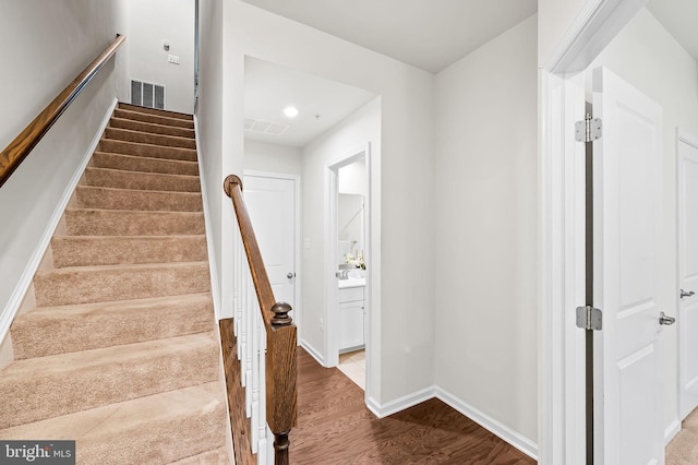 229 S Macon St, Baltimore, MD 21224 - stairway with wood finished floors, baseboards, and recessed lighting