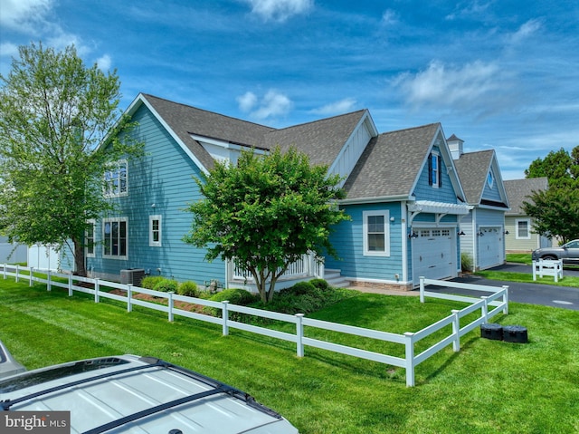 37529 Atlantic Ave Unit 11, Rehoboth Beach, DE 19971 - view of side of home with a garage, asphalt driveway, a shingled roof, and central AC