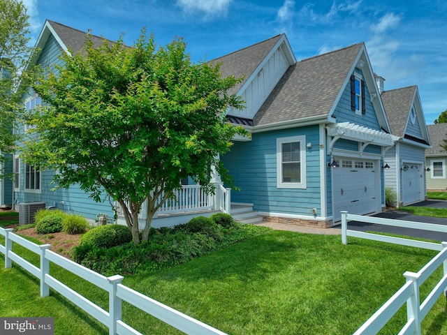 37529 Atlantic Ave Unit 11, Rehoboth Beach, DE 19971 - view of front of home with board and batten siding, roof with shingles, a garage, and driveway