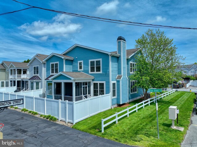37529 Atlantic Ave Unit 11, Rehoboth Beach, DE 19971 - view of front facade featuring a chimney and a sunroom