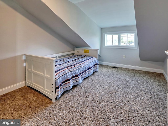 37529 Atlantic Ave Unit 11, Rehoboth Beach, DE 19971 - bedroom featuring baseboards, carpet floors, and lofted ceiling