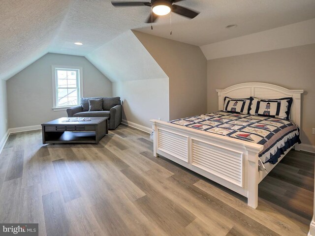 37529 Atlantic Ave Unit 11, Rehoboth Beach, DE 19971 - bedroom featuring lofted ceiling, baseboards, light wood-style flooring, a textured ceiling, and a ceiling fan