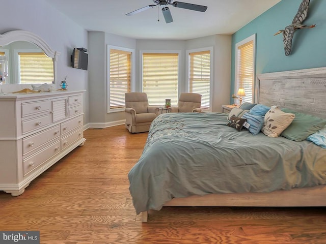 37529 Atlantic Ave Unit 11, Rehoboth Beach, DE 19971 - bedroom with multiple windows, light wood finished floors, a ceiling fan, and baseboards