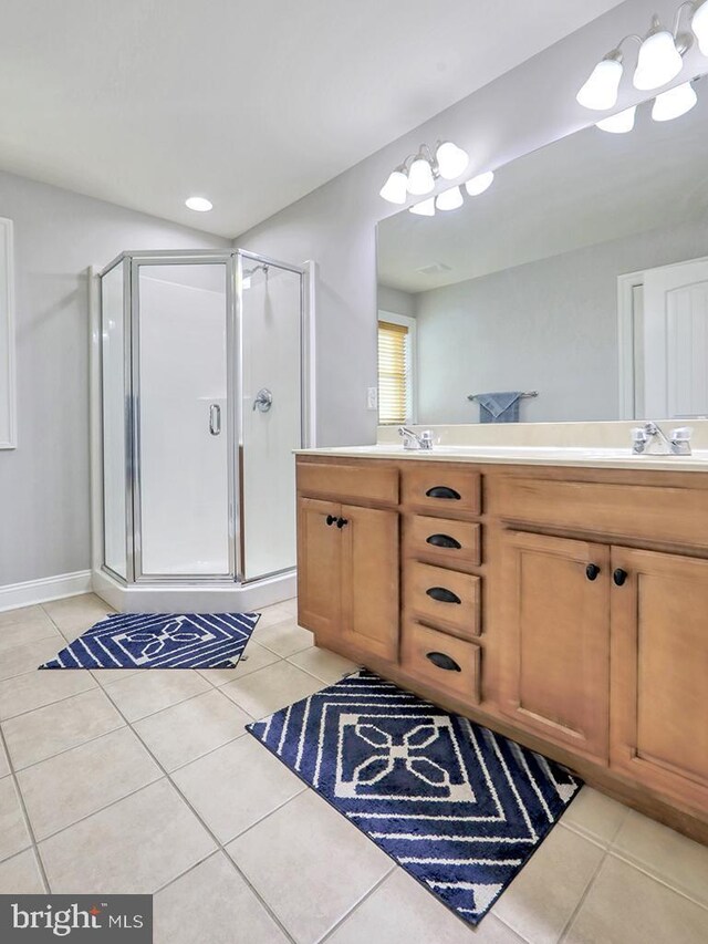 37529 Atlantic Ave Unit 11, Rehoboth Beach, DE 19971 - bathroom featuring a shower stall, double vanity, and tile patterned flooring