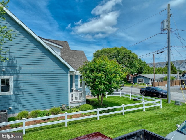 37529 Atlantic Ave Unit 11, Rehoboth Beach, DE 19971 - view of side of home featuring roof with shingles, central AC, and a residential view