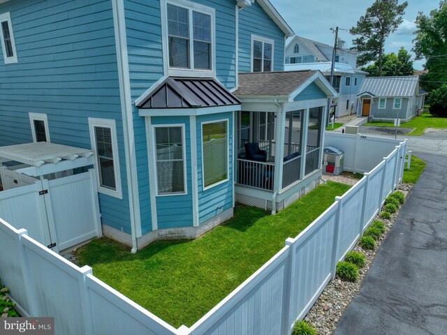37529 Atlantic Ave Unit 11, Rehoboth Beach, DE 19971 - view of property exterior with a sunroom, a standing seam roof, and metal roof