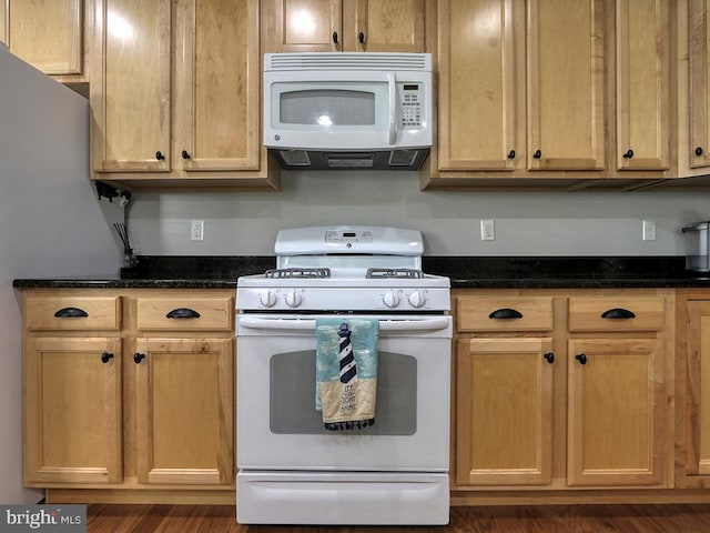 37529 Atlantic Ave Unit 11, Rehoboth Beach, DE 19971 - kitchen featuring white appliances and dark stone countertops