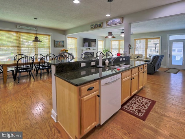 37529 Atlantic Ave Unit 11, Rehoboth Beach, DE 19971 - kitchen with dishwasher, a sink, open floor plan, wood finished floors, and a textured ceiling