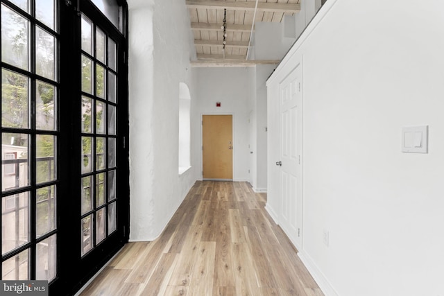 374 Shurs Ln Unit 304, Philadelphia, PA 19128 - hall with wooden ceiling with exposed beams, light wood finished floors, a towering ceiling, arched walkways, and baseboards