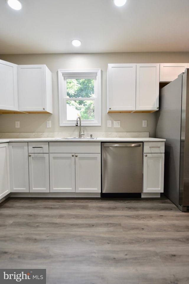 307 4th St, Seaford, DE 19973 - kitchen with appliances with stainless steel finishes, a sink, recessed lighting, white cabinets, and light countertops