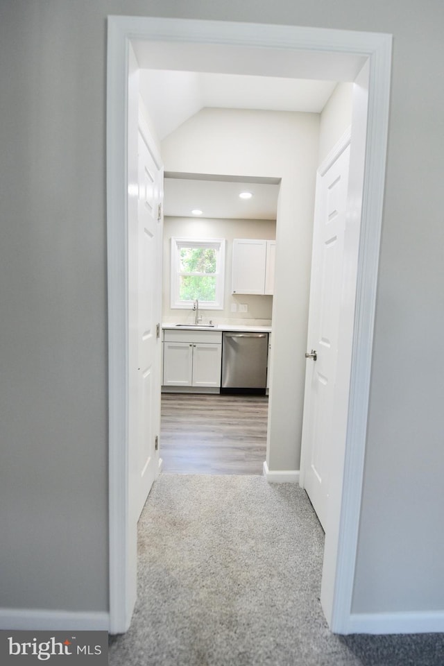 307 4th St, Seaford, DE 19973 - corridor featuring a sink, lofted ceiling, light colored carpet, and baseboards