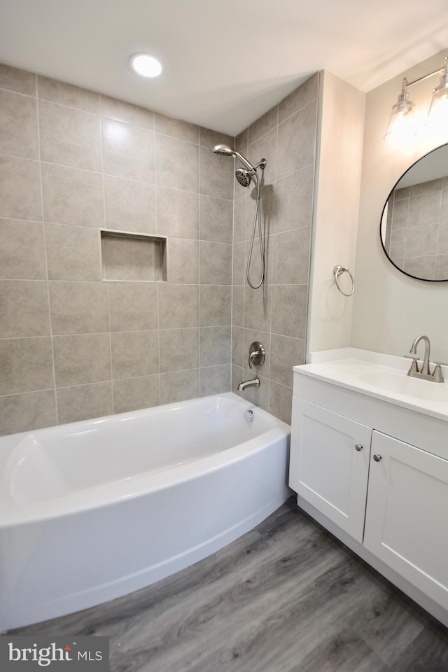 307 4th St, Seaford, DE 19973 - bathroom featuring  shower combination, wood finished floors, vanity, and recessed lighting
