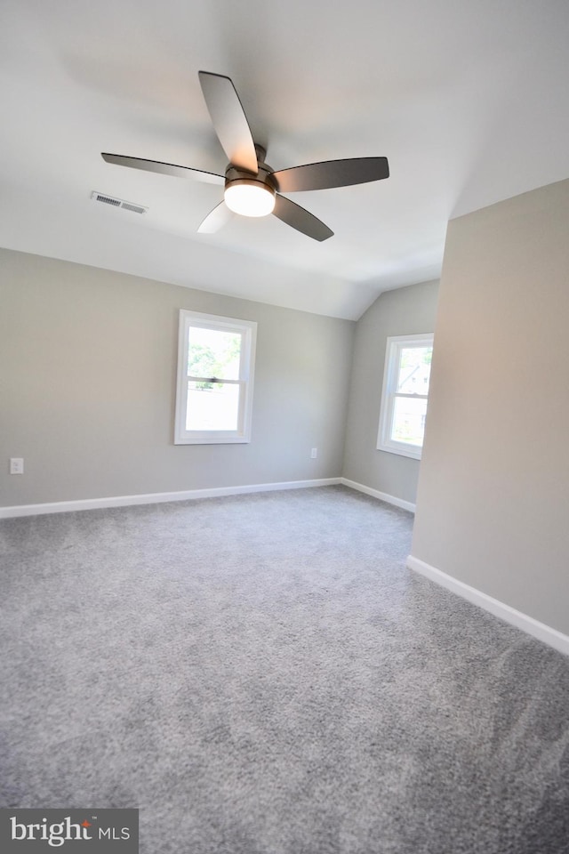 307 4th St, Seaford, DE 19973 - carpeted spare room with vaulted ceiling, a ceiling fan, and baseboards