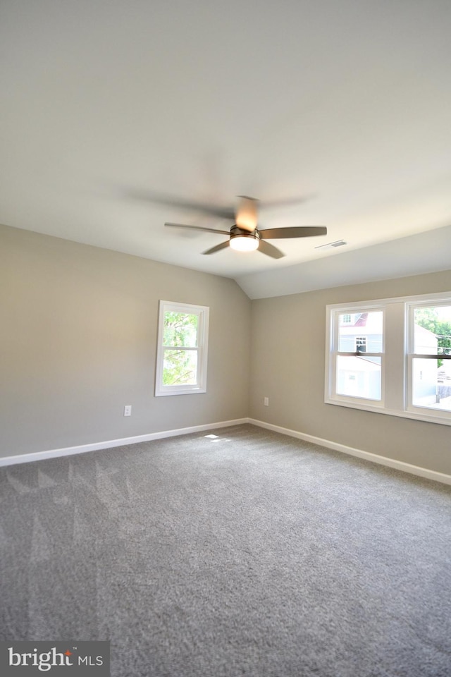 307 4th St, Seaford, DE 19973 - unfurnished room with baseboards, dark carpet, ceiling fan, and vaulted ceiling