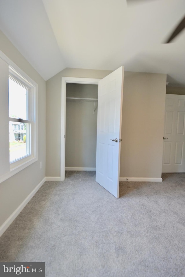 307 4th St, Seaford, DE 19973 - unfurnished bedroom featuring carpet floors, lofted ceiling, a closet, and baseboards