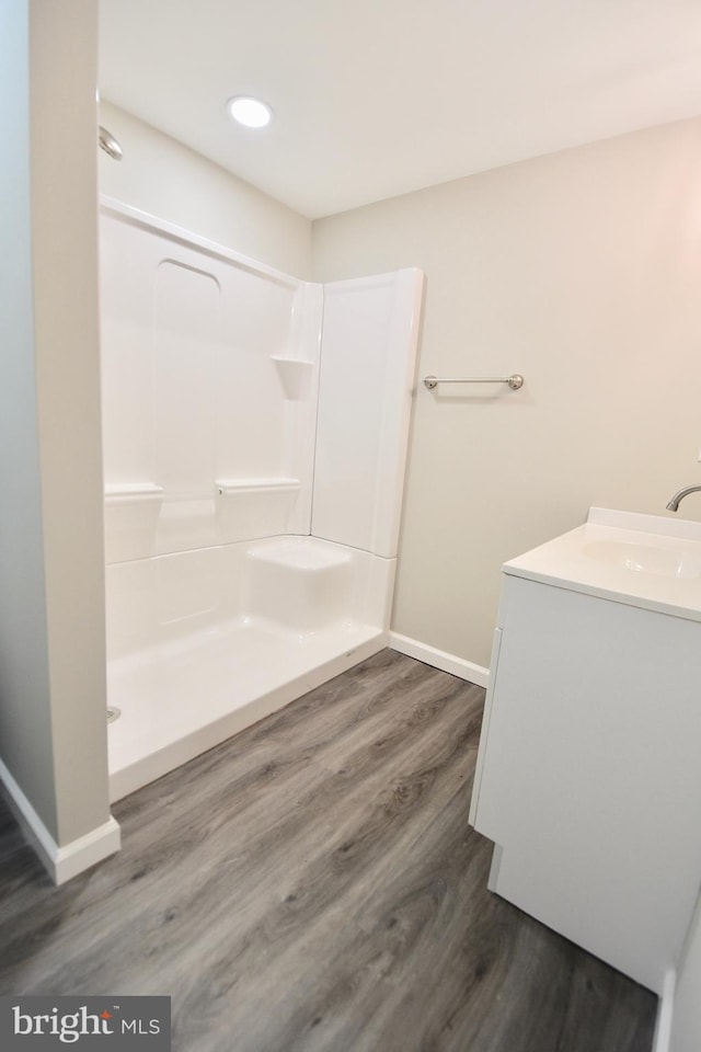 307 4th St, Seaford, DE 19973 - full bath featuring baseboards, vanity, wood finished floors, and a shower
