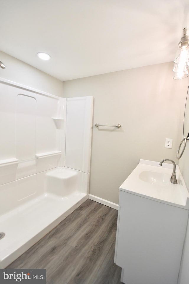 307 4th St, Seaford, DE 19973 - bathroom featuring vanity, baseboards, wood finished floors, a shower, and recessed lighting