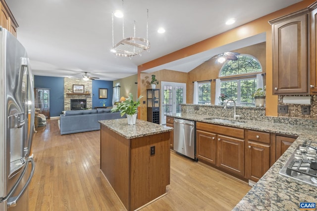 797 Willow Ridge Rd, Troy, VA 22974 - kitchen featuring stainless steel appliances, ceiling fan, light wood-style flooring, a fireplace, and a kitchen island