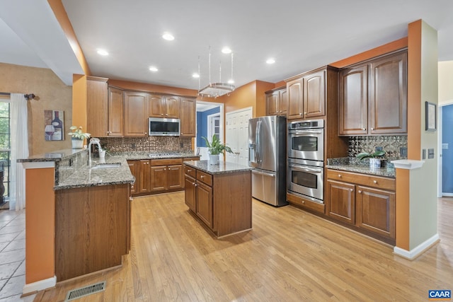 797 Willow Ridge Rd, Troy, VA 22974 - kitchen with appliances with stainless steel finishes, dark stone countertops, a peninsula, backsplash, and recessed lighting