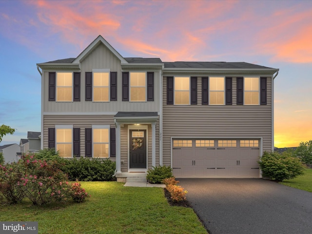 225 Norfolk Ln, Martinsburg, WV 25405 - view of front of home with an attached garage, asphalt driveway, a lawn, and board and batten siding