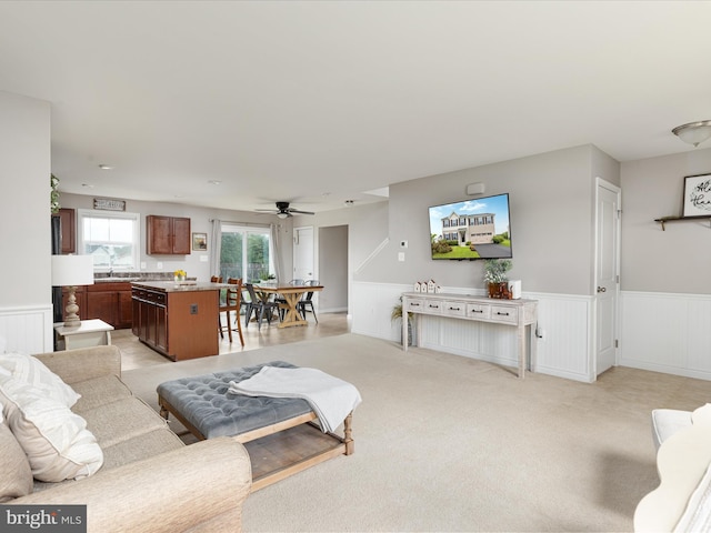 225 Norfolk Ln, Martinsburg, WV 25405 - living room featuring a wainscoted wall, ceiling fan, light carpet, and a decorative wall
