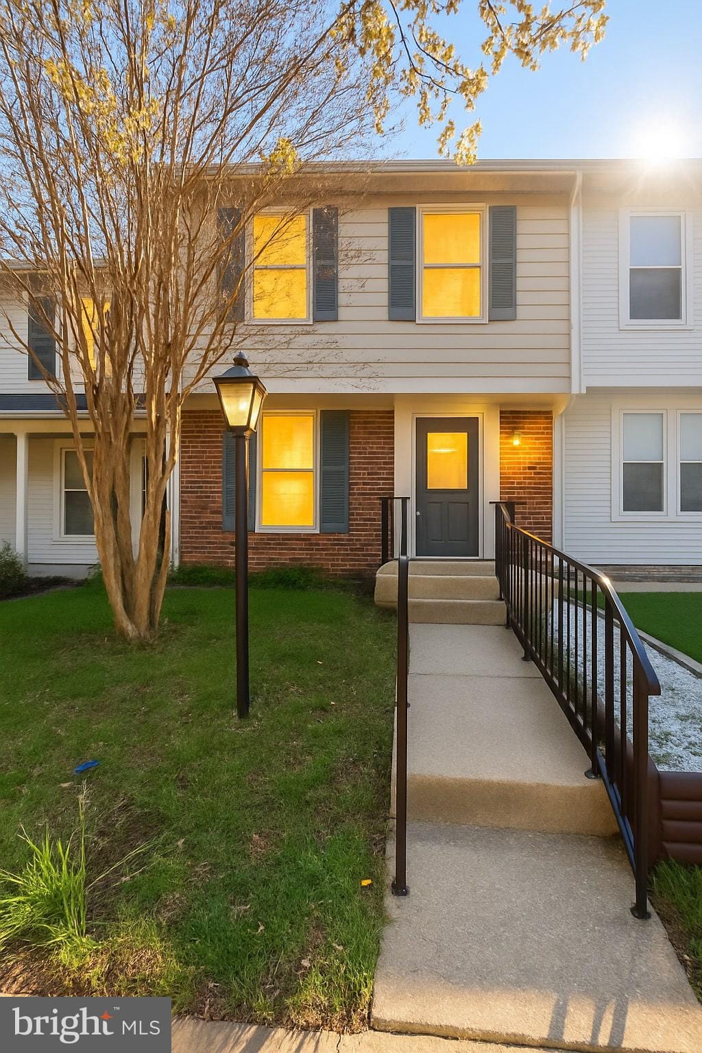 8141 Mandan Ter, Greenbelt, MD 20770 - townhome / multi-family property with a front yard and brick siding