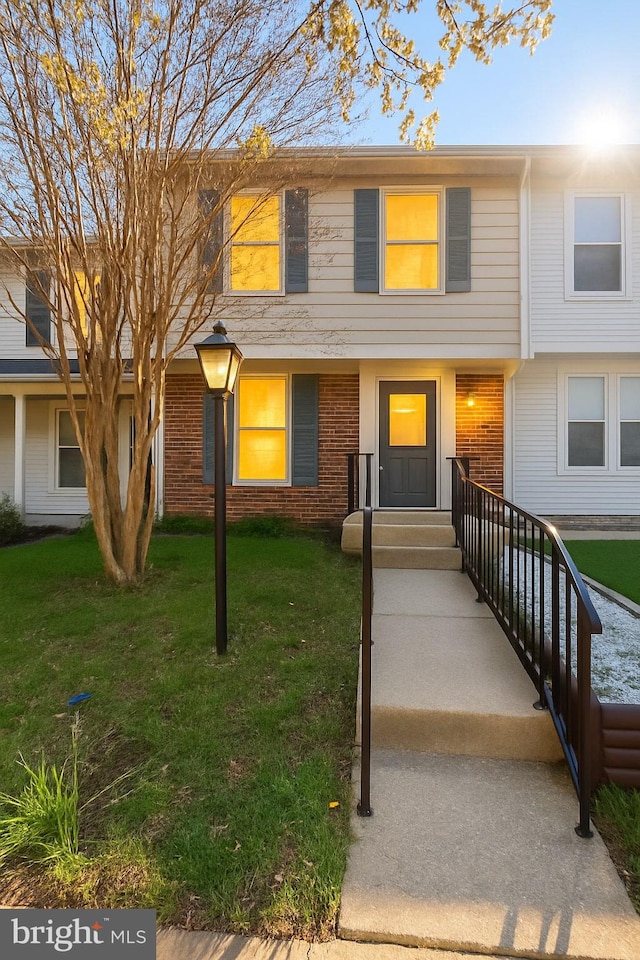 8141 Mandan Ter, Greenbelt, MD 20770 - townhome / multi-family property with a front yard and brick siding
