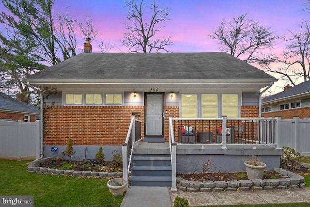 504 Rocklyn Ave, Baltimore, MD 21208 - bungalow-style house featuring brick siding, covered porch, and a chimney