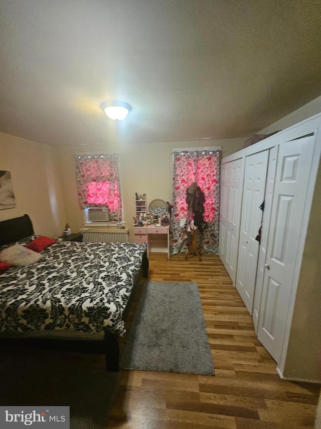421 Folcroft St, Baltimore, MD 21224 - bedroom featuring wood finished floors, two closets, and cooling unit