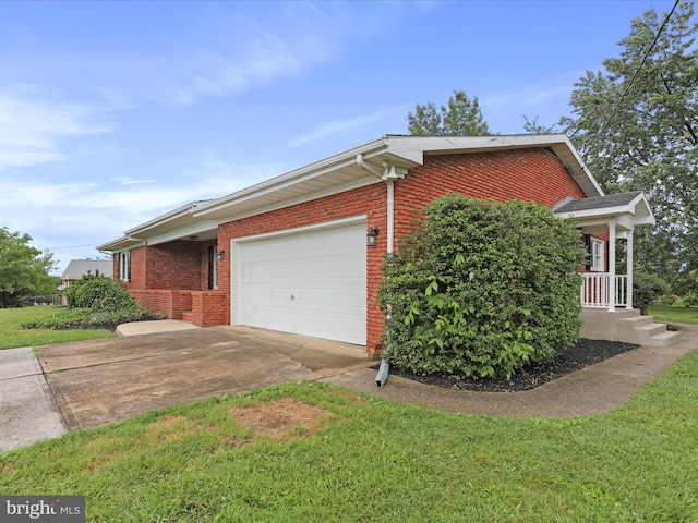 47 Picture Mountain Dr, Martinsburg, WV 25404 - view of side of property with an attached garage, brick siding, concrete driveway, and a lawn
