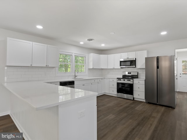 47 Picture Mountain Dr, Martinsburg, WV 25404 - kitchen with appliances with stainless steel finishes, a peninsula, dark wood-style flooring, light countertops, and recessed lighting
