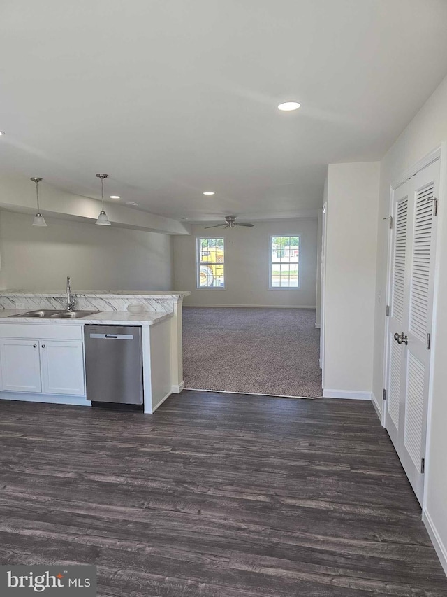 239 Rojan Rd Unit 113, Dover, DE 19901 - kitchen with stainless steel dishwasher, a sink, a ceiling fan, dark wood-style floors, and baseboards