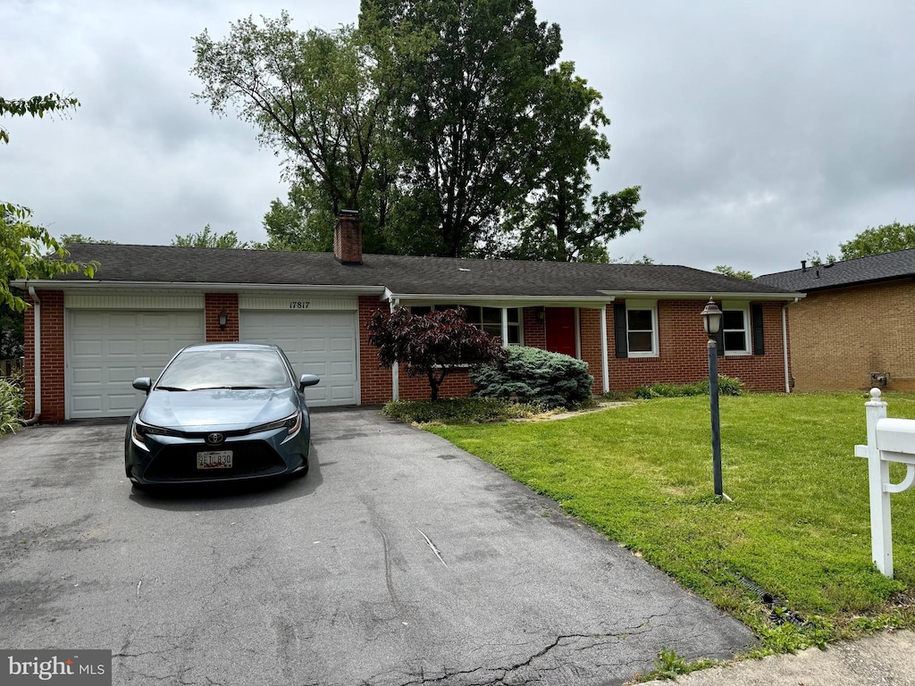 17817 Greentree Ln, Hagerstown, MD 21740 - single story home with driveway, an attached garage, a front lawn, and brick siding