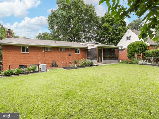 905 Peele Pl, Alexandria, VA 22304 - rear view of house with cooling unit, a sunroom, brick siding, and a chimney